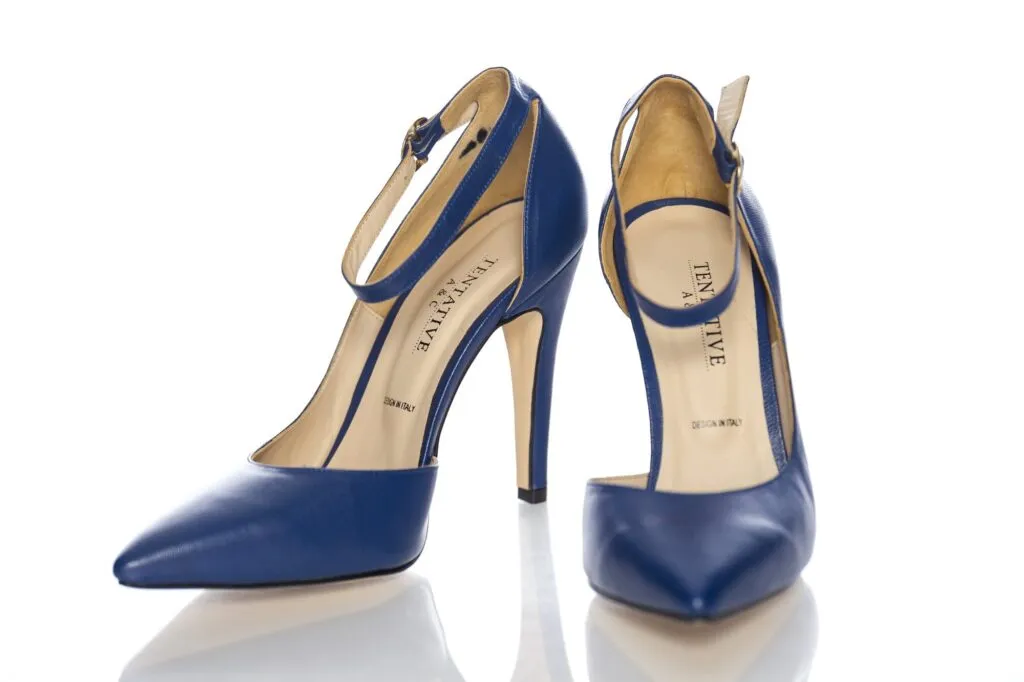Pair of handmade navy heels with ankle straps on white