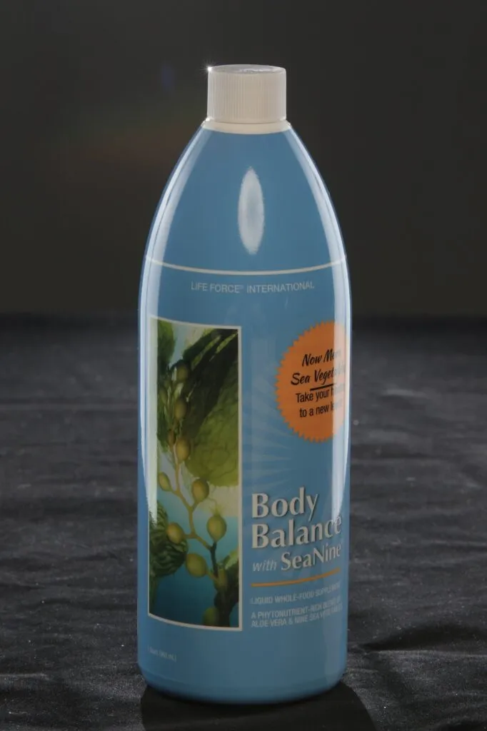 Life Force Body Balance bottle lit on a dark studio set