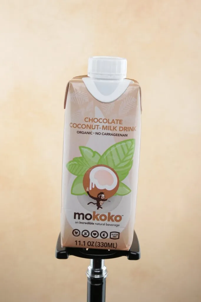 Mokoko chocolate coconut milk carton on a warm studio backdrop