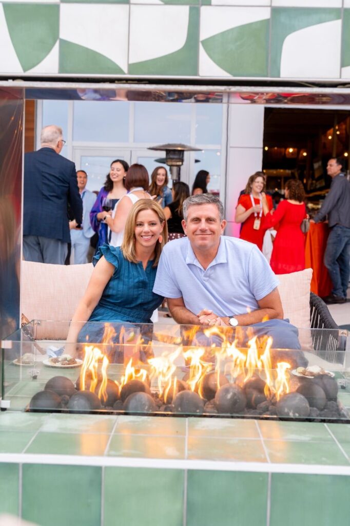 Two guests relaxing by a fire pit at the Marzul grand opening
