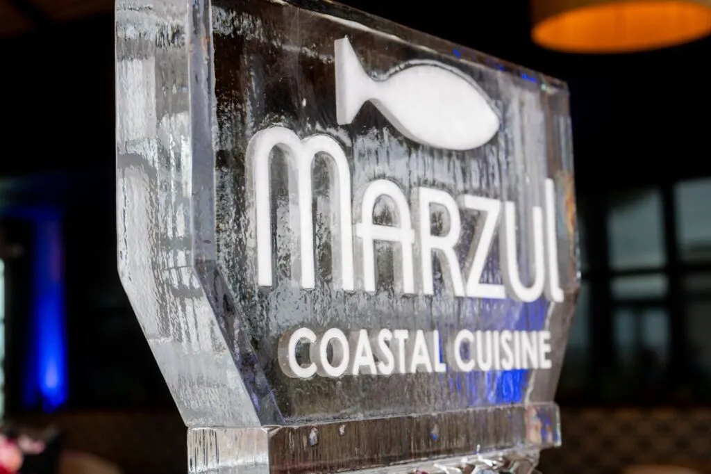 The Marzul Coastal Cuisine ice sculpture glowing at the grand opening