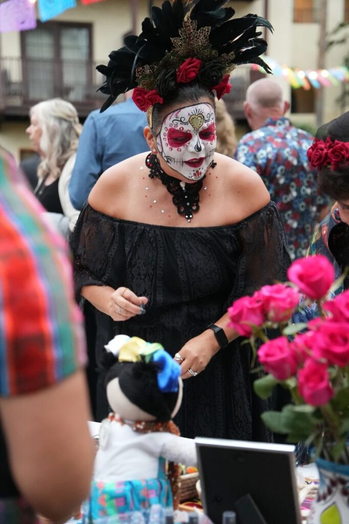 A gala guest in sugar skull makeup and a black dress at the Corazon de Vida Noche de Gala