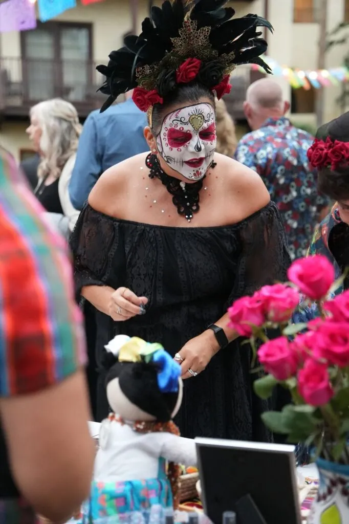 A gala guest in sugar skull makeup and a black dress at the Corazon de Vida Noche de Gala