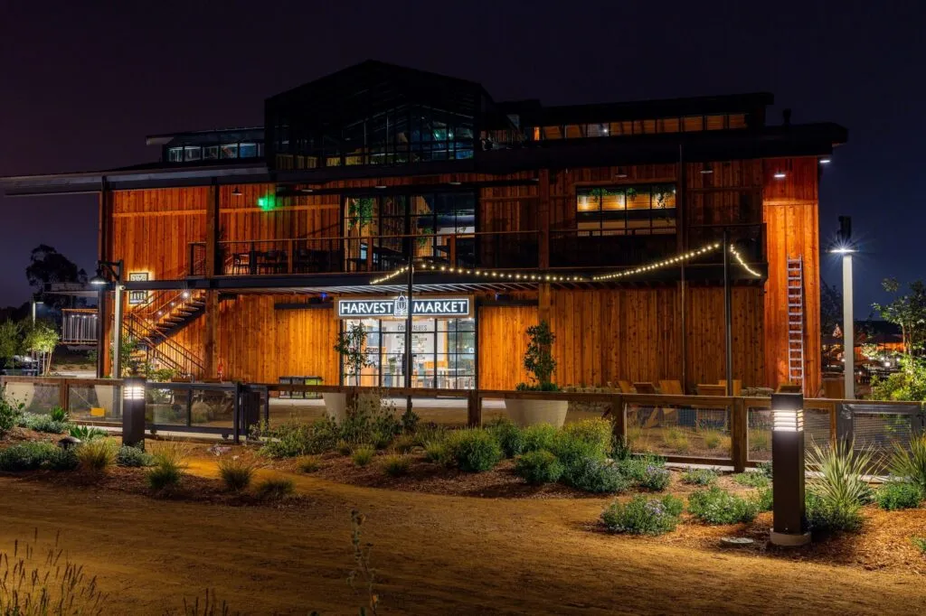 The Harvest Market barn at Fox Point Farms lit up at night