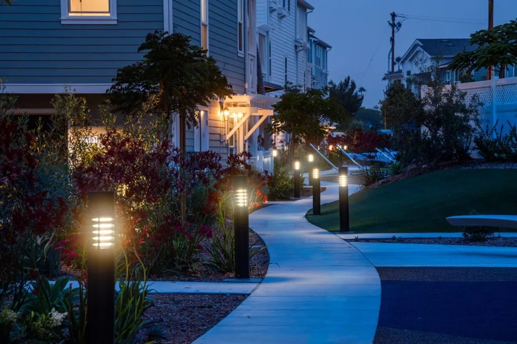 Lit garden path through a new community in Carlsbad at blue hour