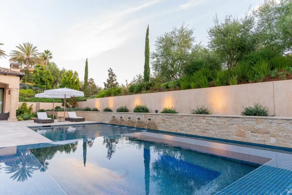 Pool and lit garden wall at an estate in Rancho Santa Fe