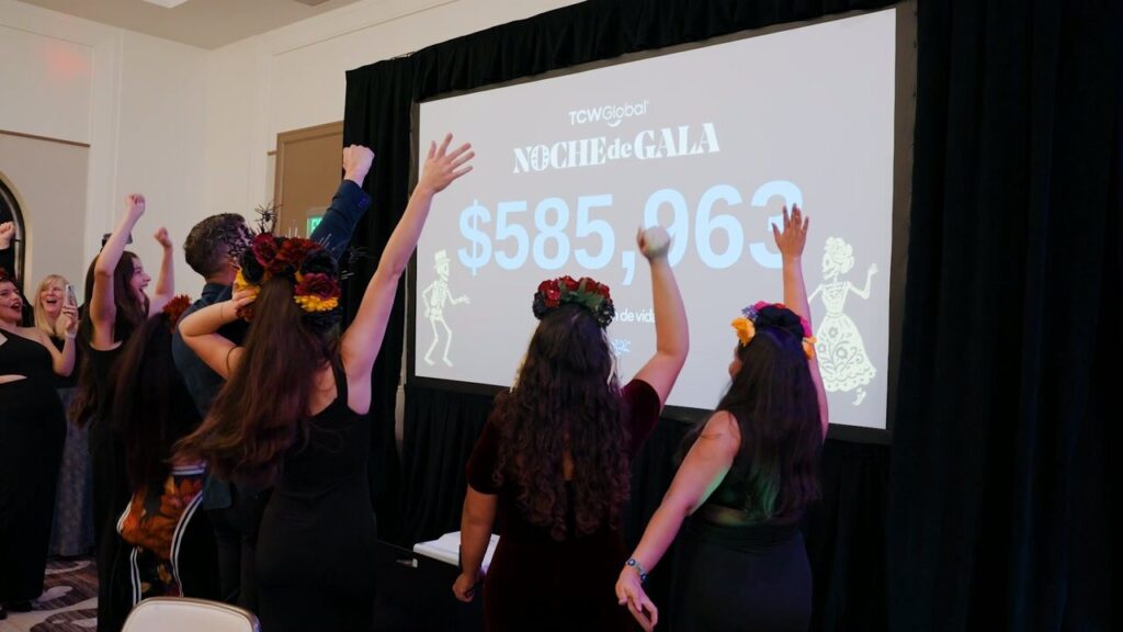 Guests at the Corazón de Vida Noche de Gala in La Jolla throwing their arms up in celebration