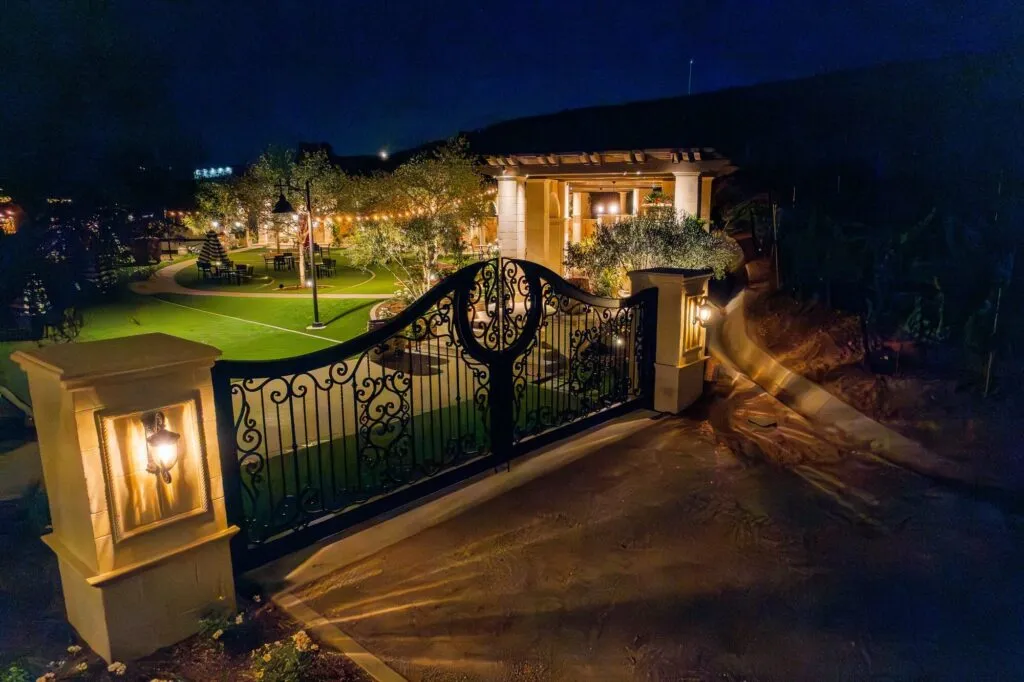 Iron gate and lanterns lit at night at a winery in Temecula