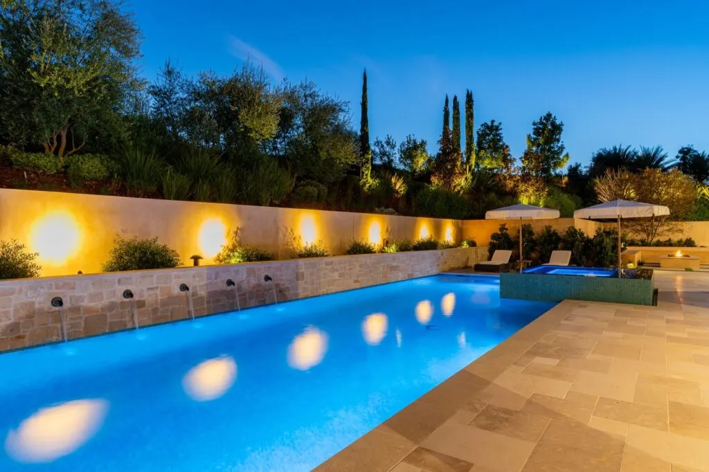 Pool glowing blue at dusk at a Rancho Santa Fe estate