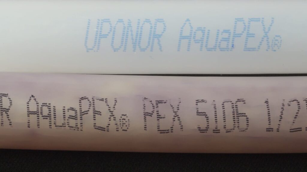 Macro close-up of Uponor AquaPEX pipe markings