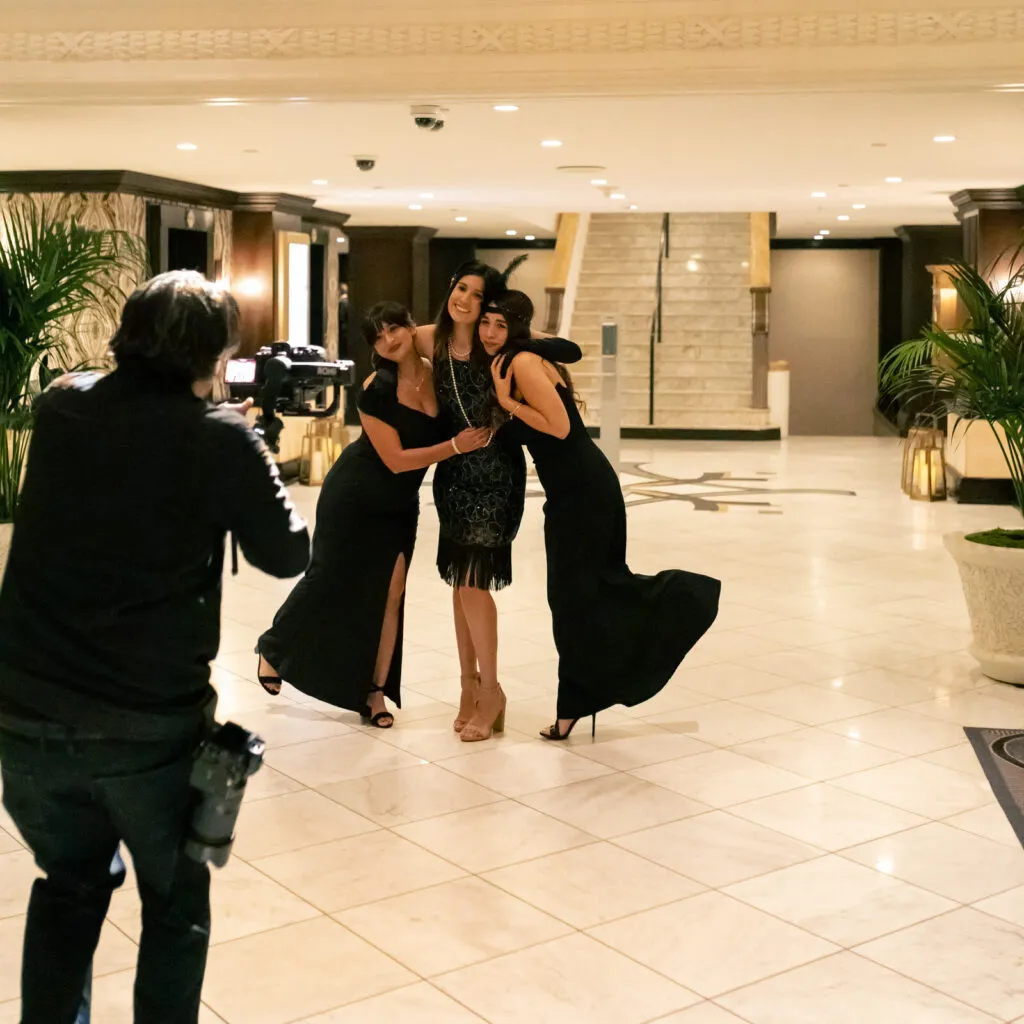 Behind the scenes on a video shoot: filming guests with a gimbal camera in a hotel lobby at a gala